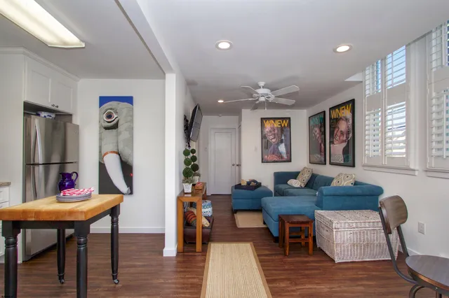 a living room with furniture a rug and a table