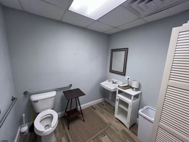 a bathroom with a toilet a sink and a mirror