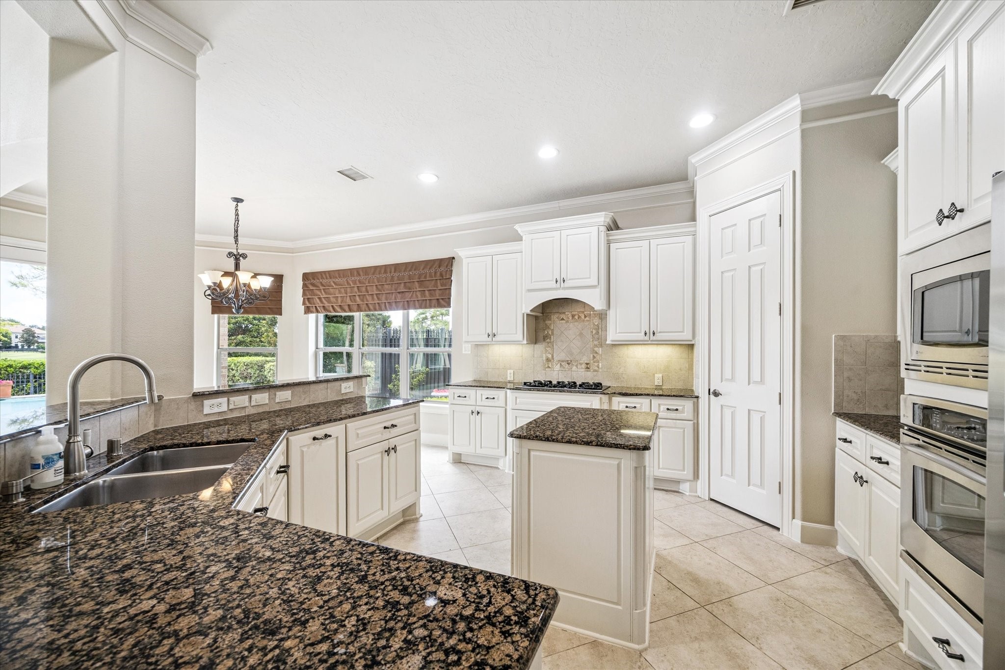 3327 Louvre Lane Houston, TX 77082 - Photo 14 of 31 a kitchen with stainless steel appliances granite countertop a sink stove and refrigerator
