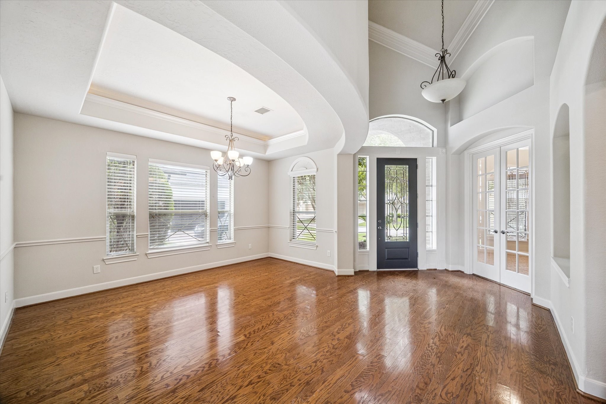 3327 Louvre Lane Houston, TX 77082 - Photo 3 of 31 a view of an empty room with wooden floor and a window