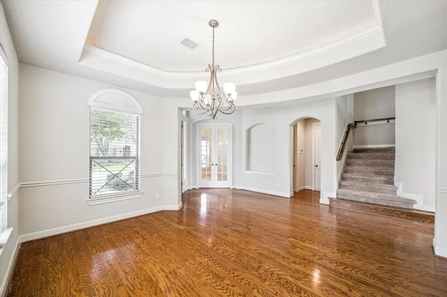 a view of an empty room with a fireplace and a window