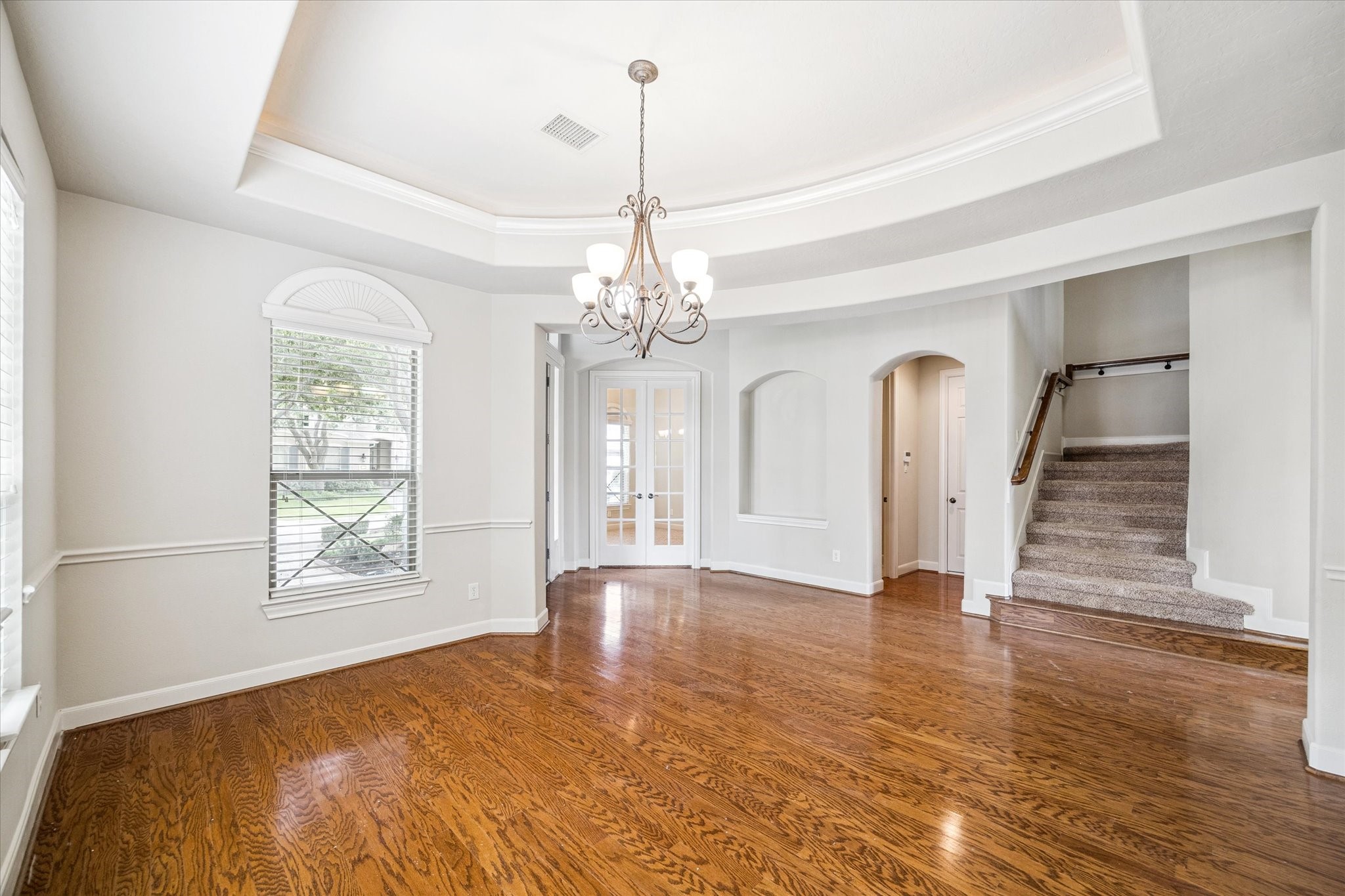 3327 Louvre Lane Houston, TX 77082 - Photo 6 of 31 a view of an empty room with window and wooden floor