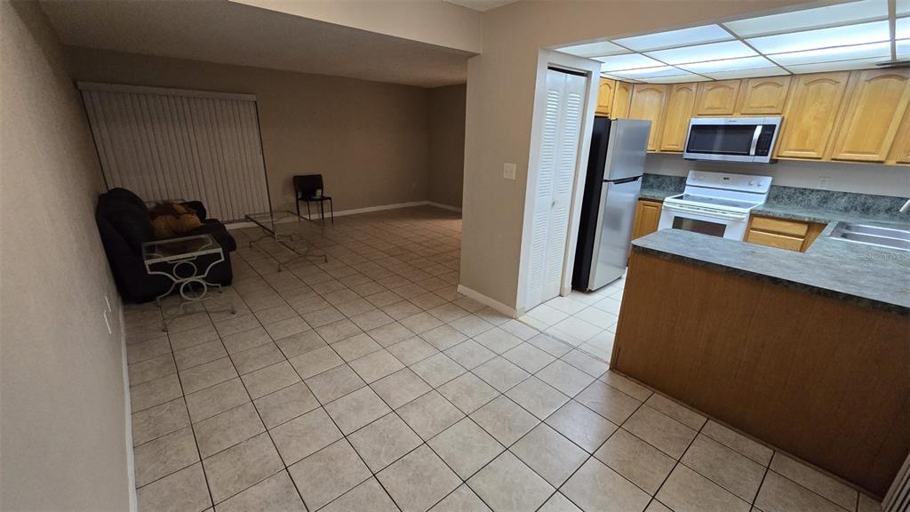 a kitchen with stainless steel appliances a refrigerator and a stove top oven