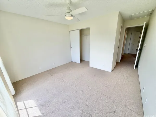 an empty room with windows and white walls