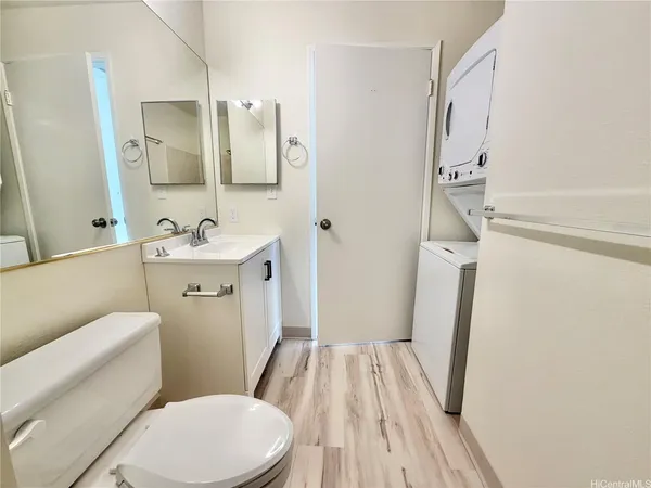 a bathroom with a sink a toilet a mirror and shower