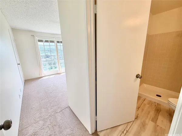 a view of a hallway to rooms