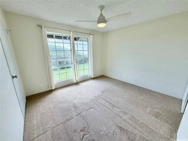 an empty room with windows and outdoor view