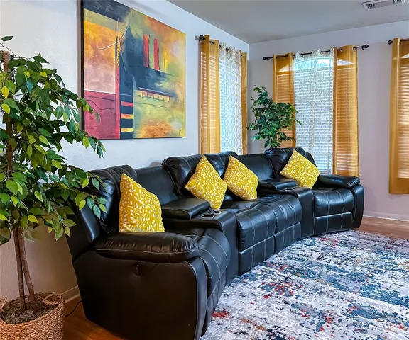 a living room with furniture and a potted plant