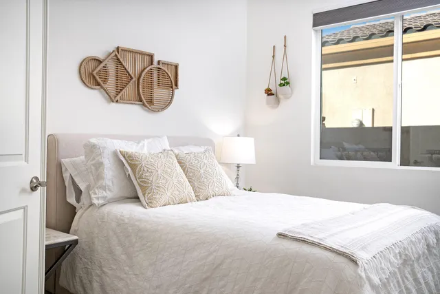 a bedroom with a bed and a window