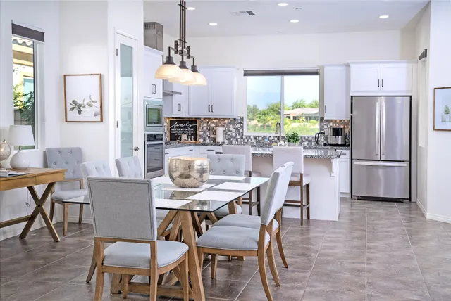 a view of a dining room with furniture a chandelier and wooden floor