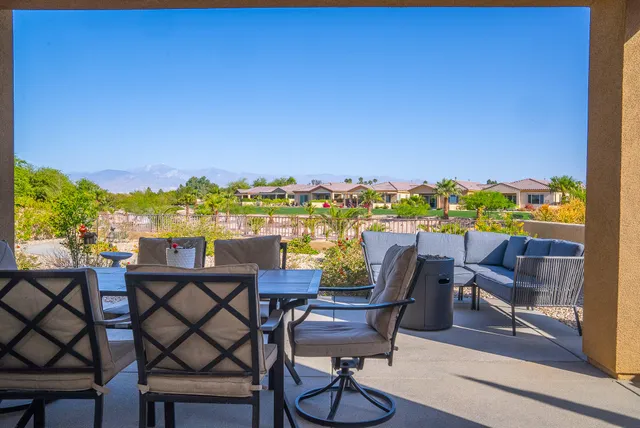 a view of a chairs and table in patio