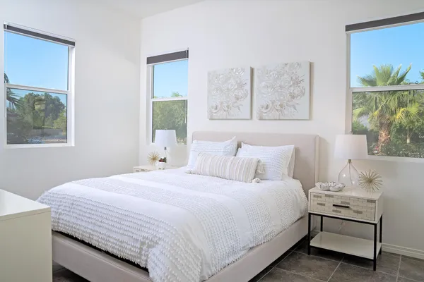 a bedroom with a bed and a painting on the wall