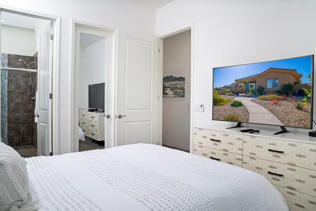 a bedroom with a bed and a flat screen tv