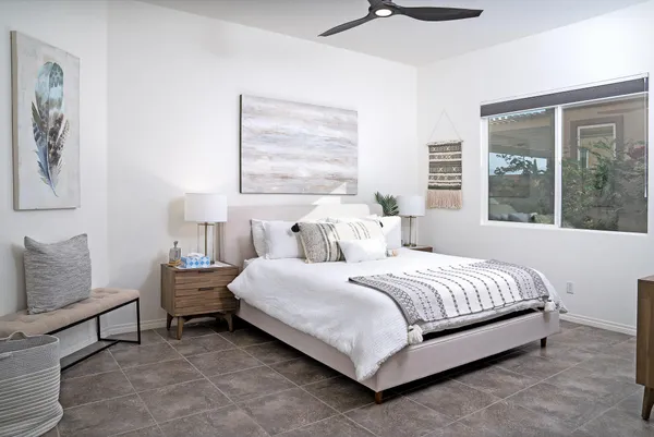 a bedroom with a bed and large window