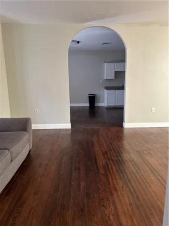a room with wooden floor and furniture