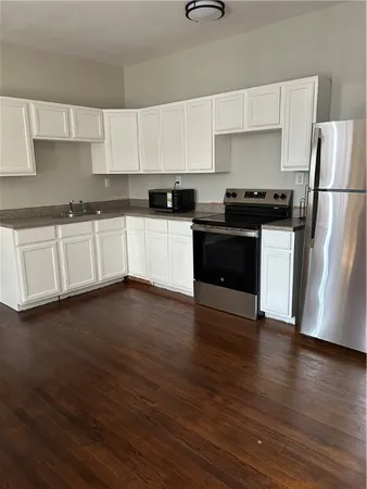 a kitchen with white cabinets and a sink