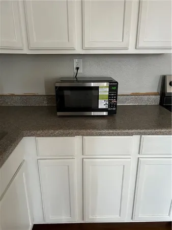 a metallic refrigerator freezer sitting in a kitchen
