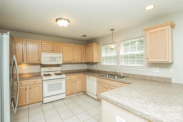 a kitchen with a stove a sink and a refrigerator