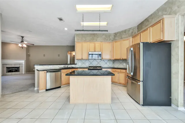 a kitchen with stainless steel appliances granite countertop a refrigerator sink and cabinets