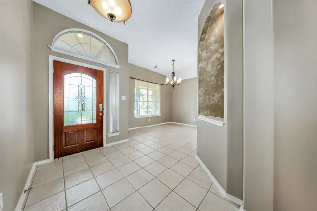 an empty room with windows and mirror