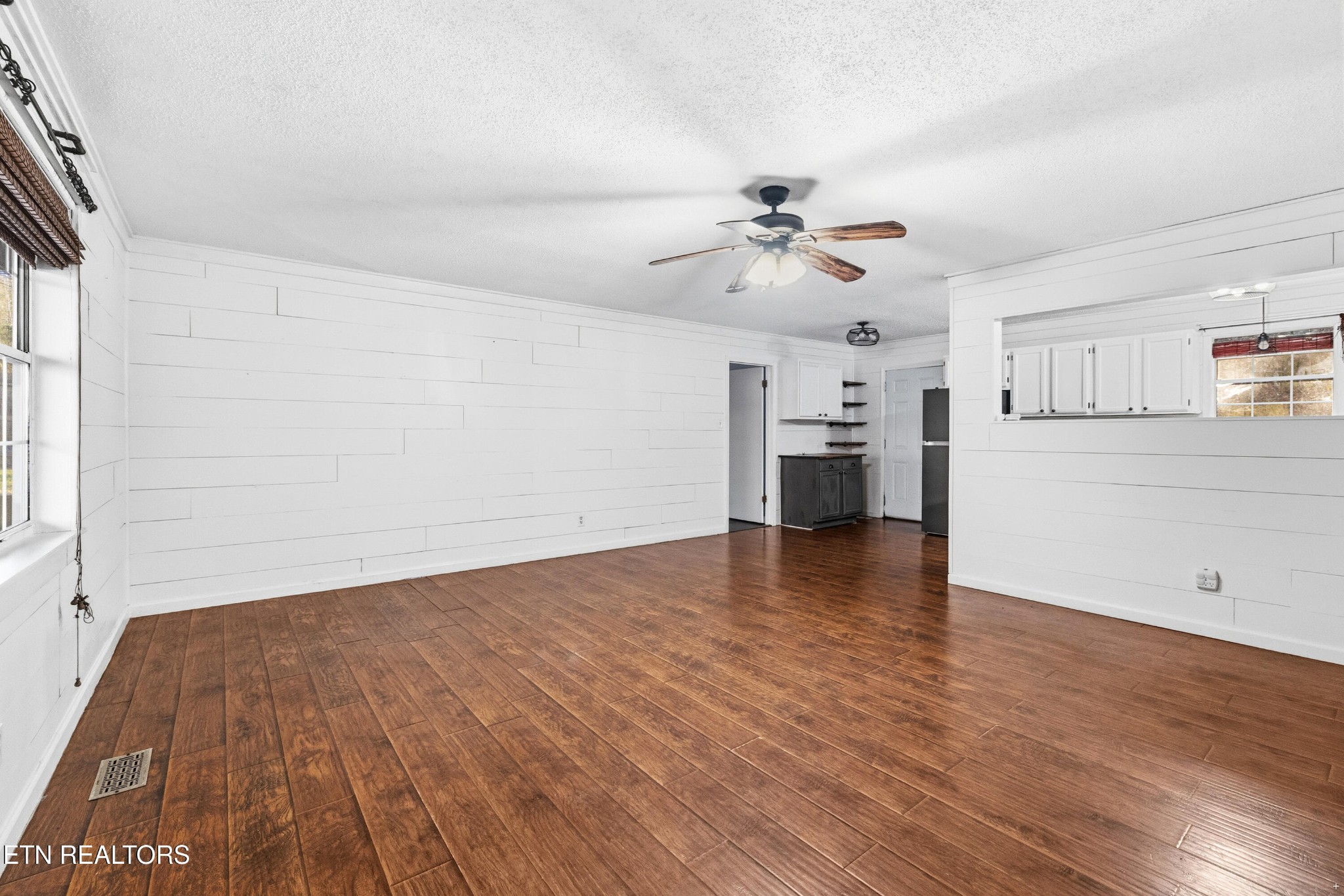 3214 Long Hollow Road Powell, TN 37849 - Photo 5 of 23 a view of a kitchen with a dishwasher a kitchen island hardwood floor and a ceiling fan