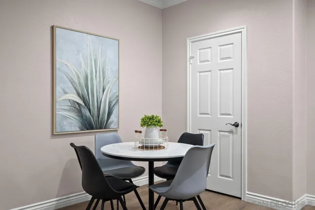 a living room with furniture kitchen view and large windows
