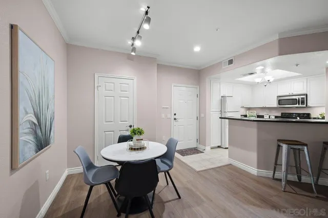 a living room with stainless steel appliances kitchen island granite countertop furniture a rug kitchen view and a window
