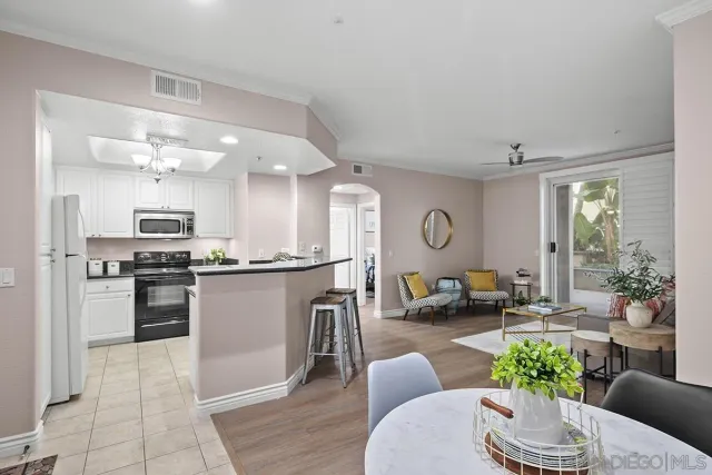 a kitchen with stainless steel appliances a sink a stove and cabinets