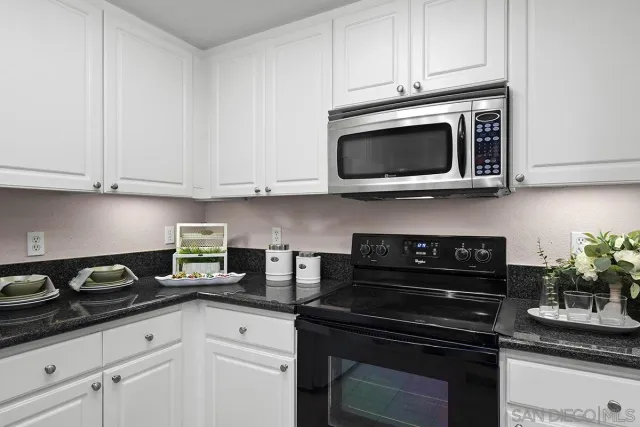 a large kitchen with a table and chairs