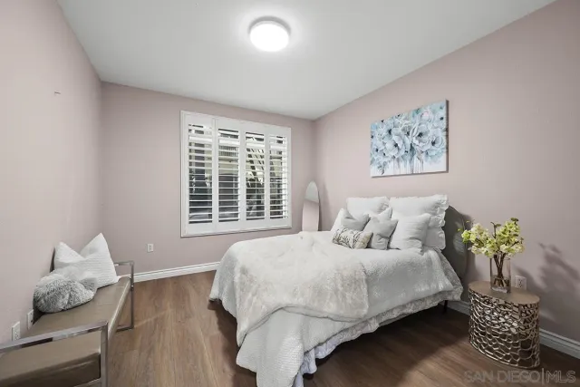 a bedroom with a bed and a painting on the wall