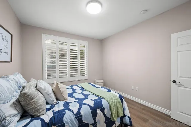 a bathroom with a granite countertop sink toilet and a mirror