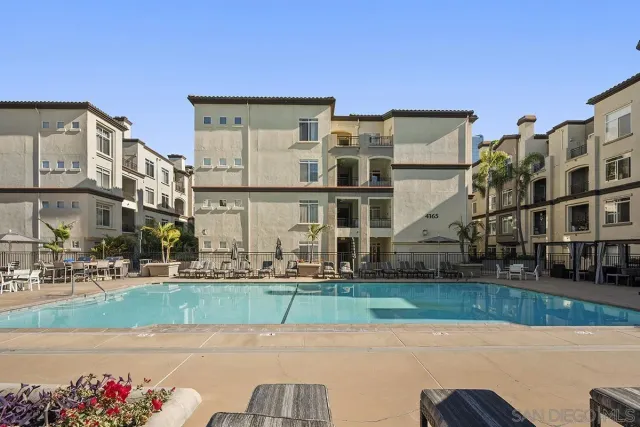 a living room with patio furniture and a large window