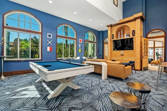 a work room with furniture and a large window