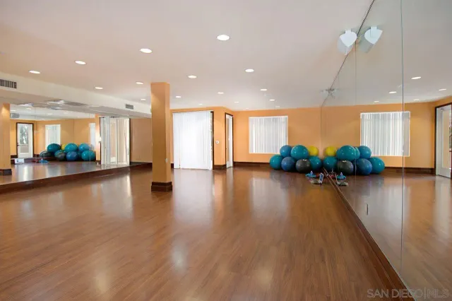 a room with gym equipment and air hockey table