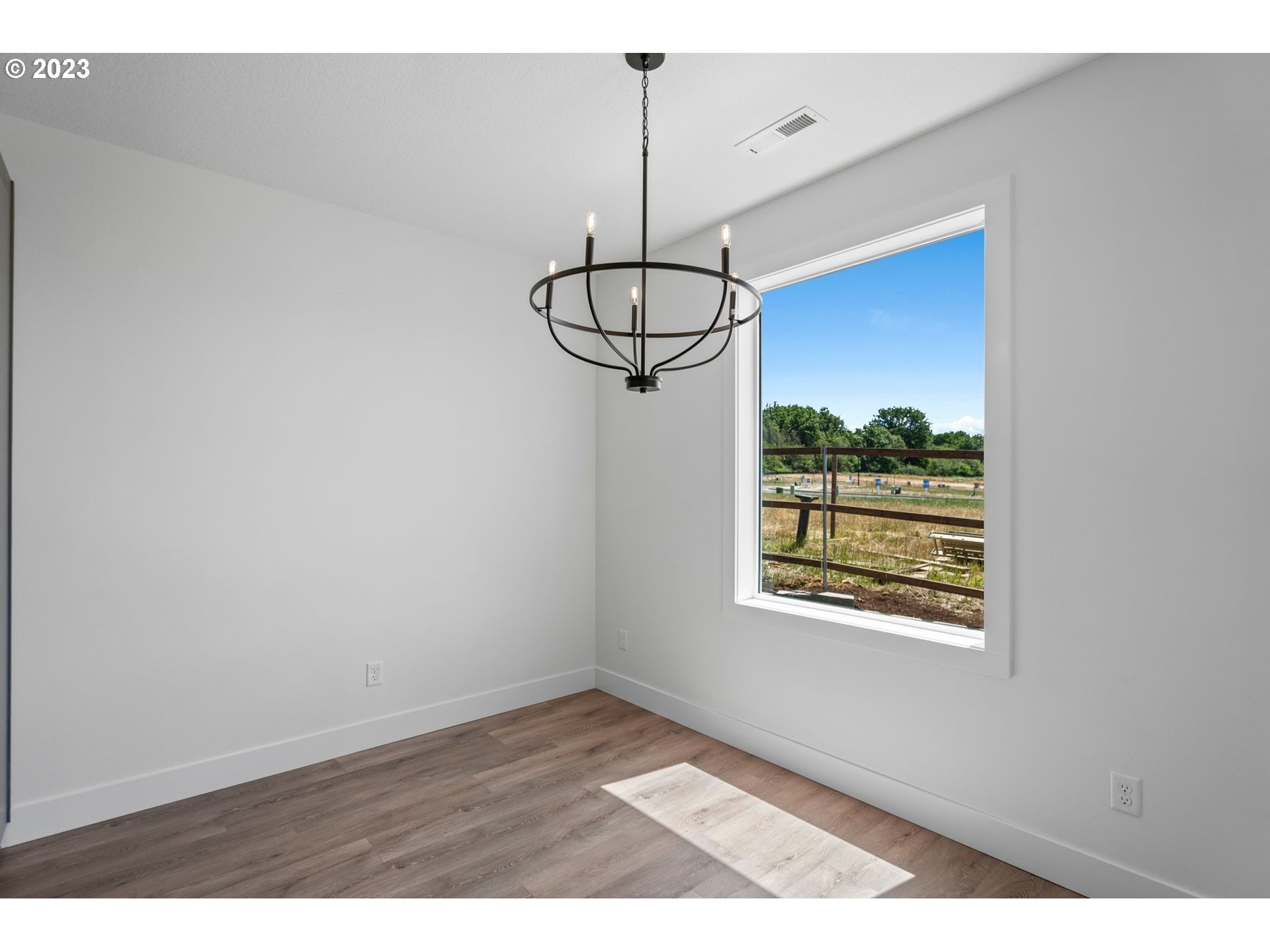 719 Northwest 175th Way Ridgefield, WA 98642 - Photo 8 of 33 a view of a room with window and wooden floor