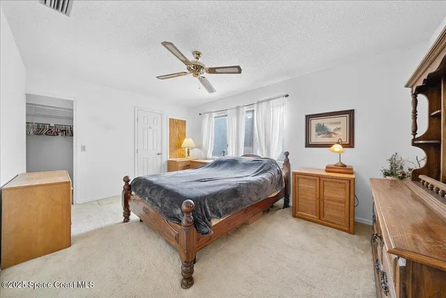 a spacious bedroom with a bed and a couch