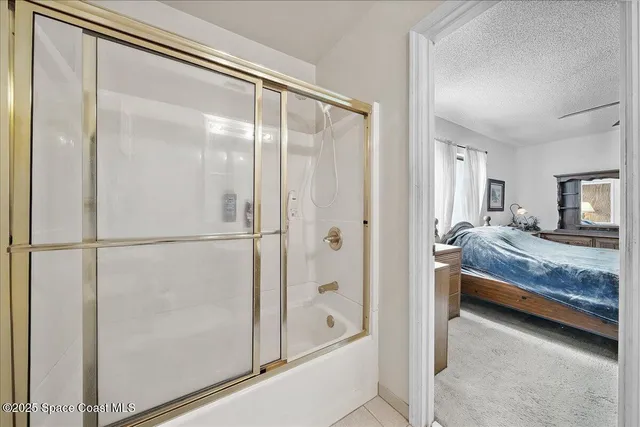 a bedroom with a bed and a mirror