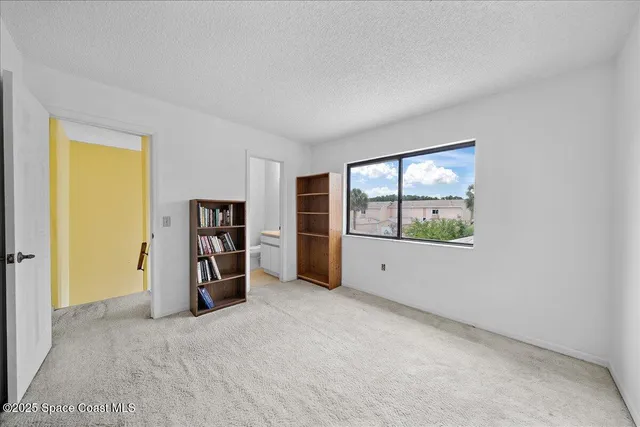 an empty room with a window and closet