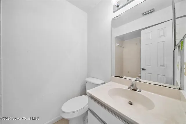 a bathroom with a sink a toilet and mirror