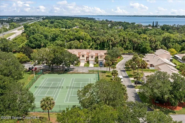 an aerial view of a houses with a yard