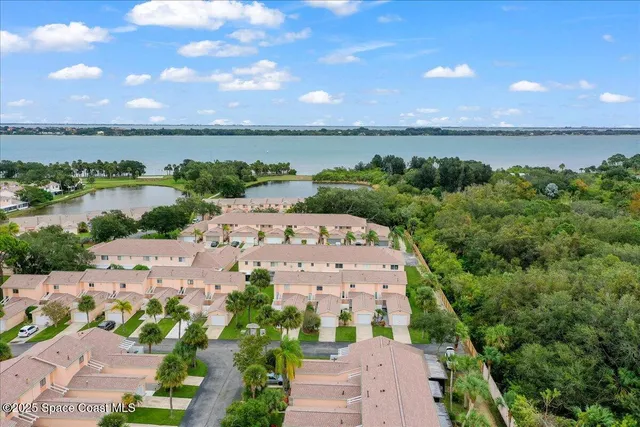 an aerial view of a house with a lake view