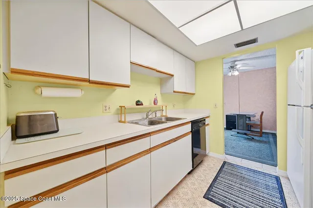 a kitchen with sink cabinets and a wooden floor