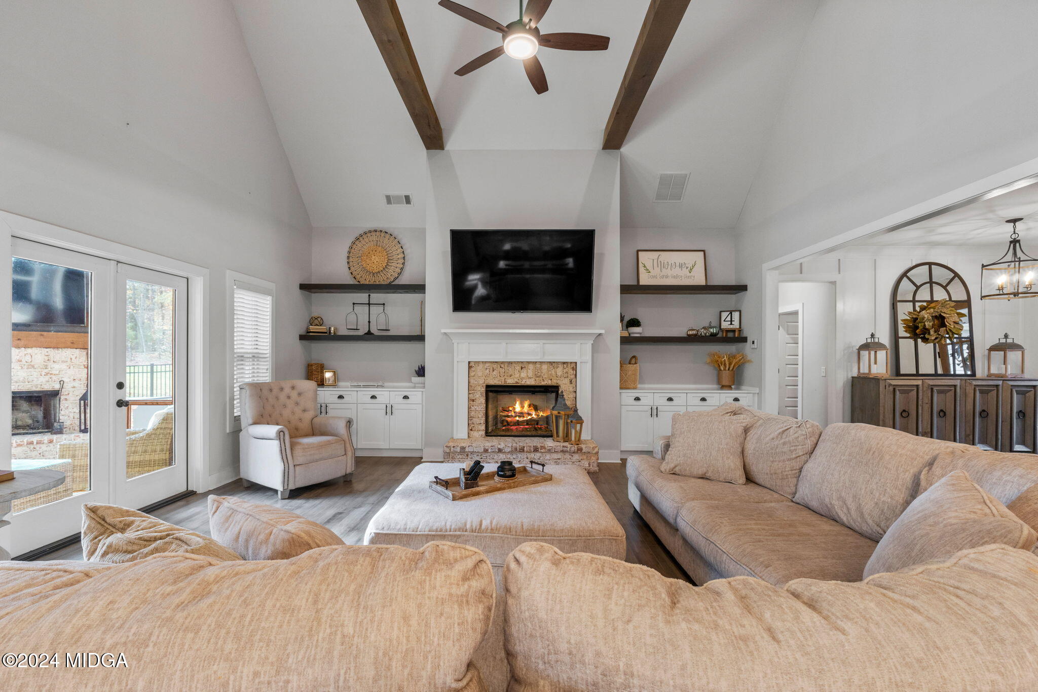 131 Belmont Way Forsyth, GA 31029 - Photo 12 of 68 a living room with furniture a flat screen tv and a fireplace