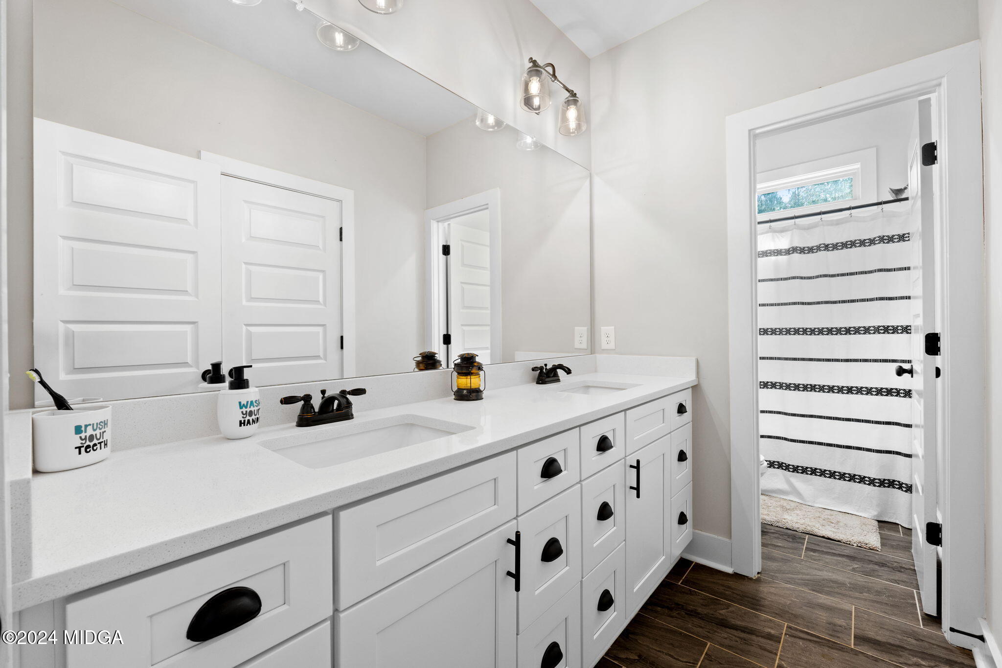 131 Belmont Way Forsyth, GA 31029 - Photo 34 of 68 a bathroom with a double vanity sink and mirror