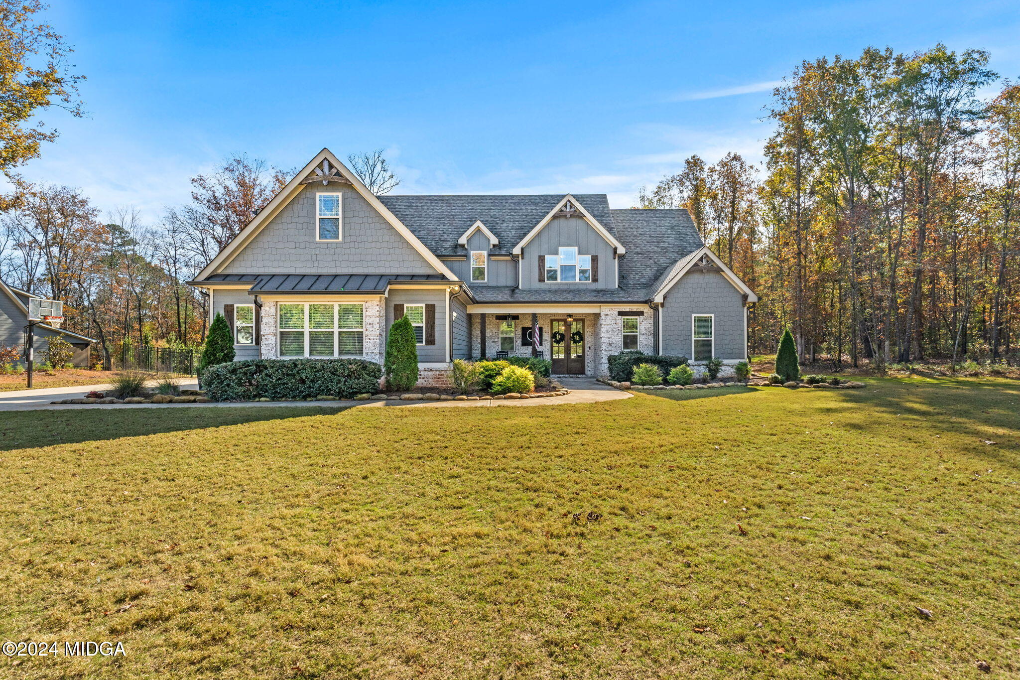 131 Belmont Way Forsyth, GA 31029 - Photo 4 of 68 a front view of a house with swimming pool