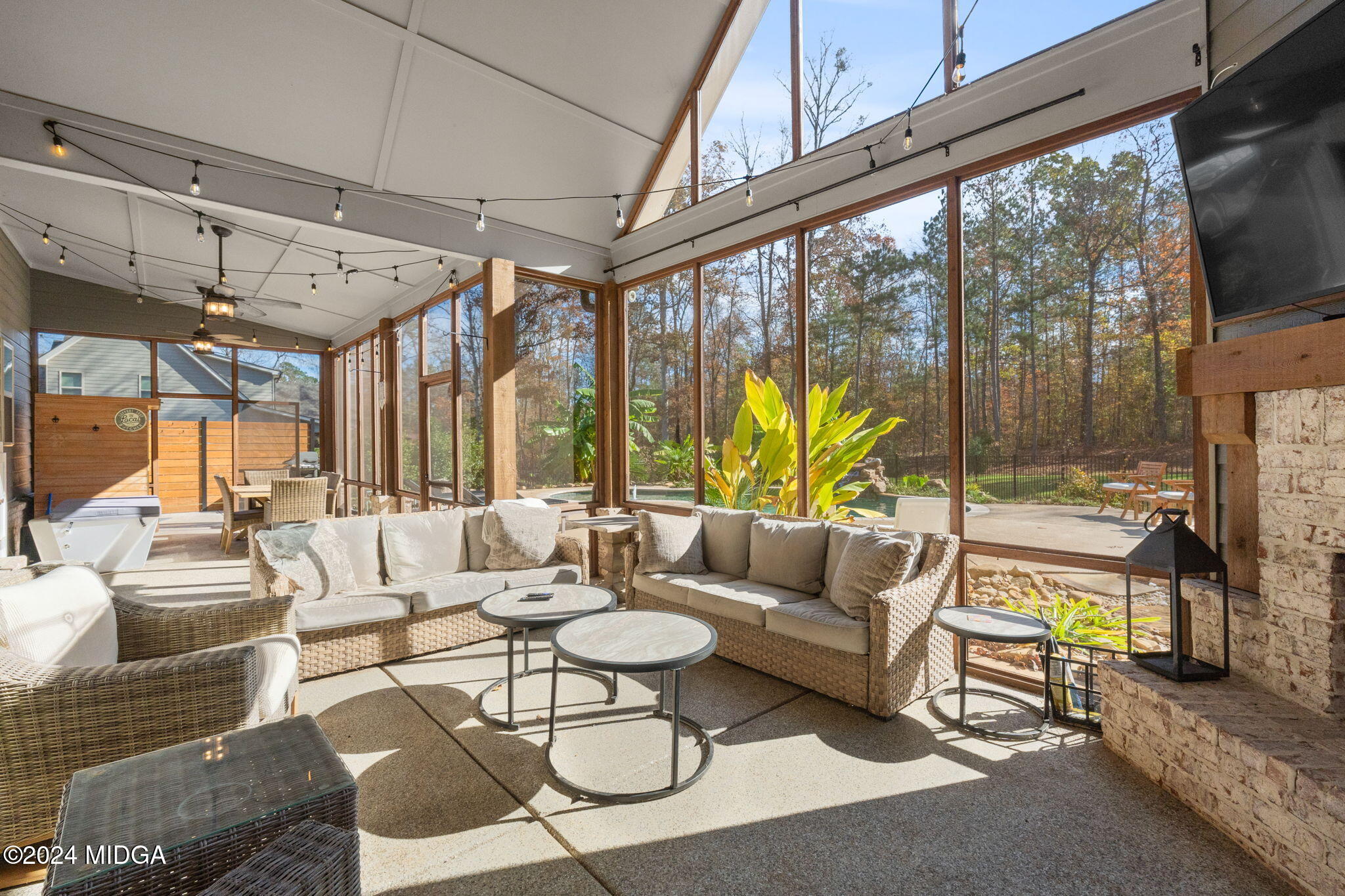131 Belmont Way Forsyth, GA 31029 - Photo 47 of 68 a living room with furniture a flat screen tv and floor to ceiling window