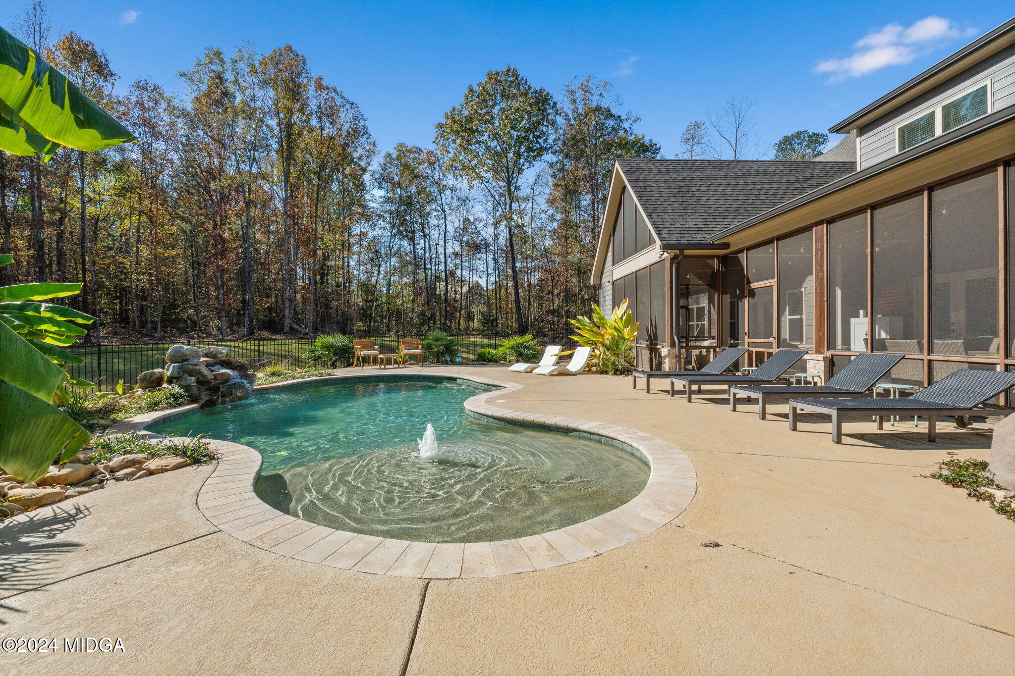 131 Belmont Way Forsyth, GA 31029 - Photo 51 of 68 a view of a swimming pool with lawn chairs and plants