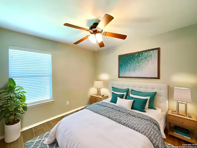 a bedroom with bed and a potted plant