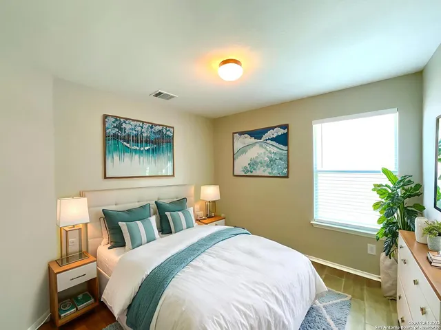 a bedroom with bed and a window