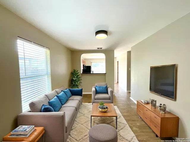 a living room with furniture and a flat screen tv